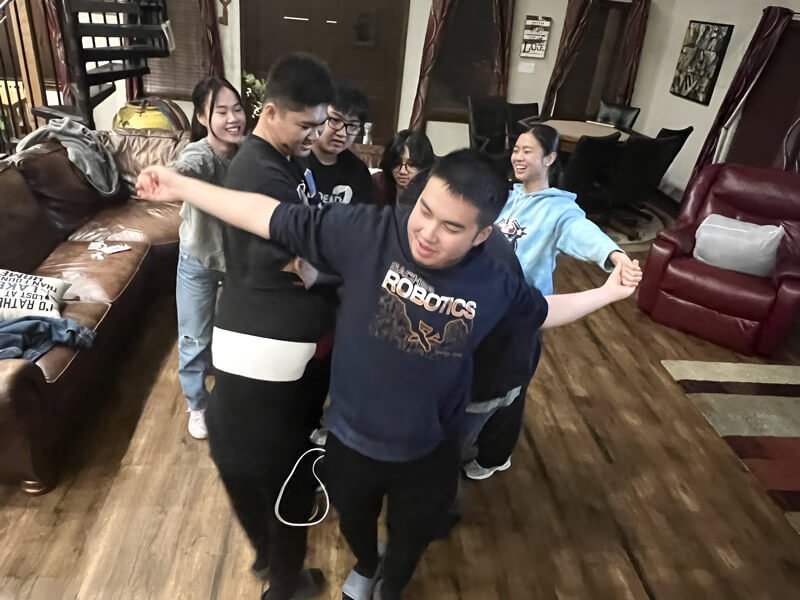 Students laughing during a team challenge